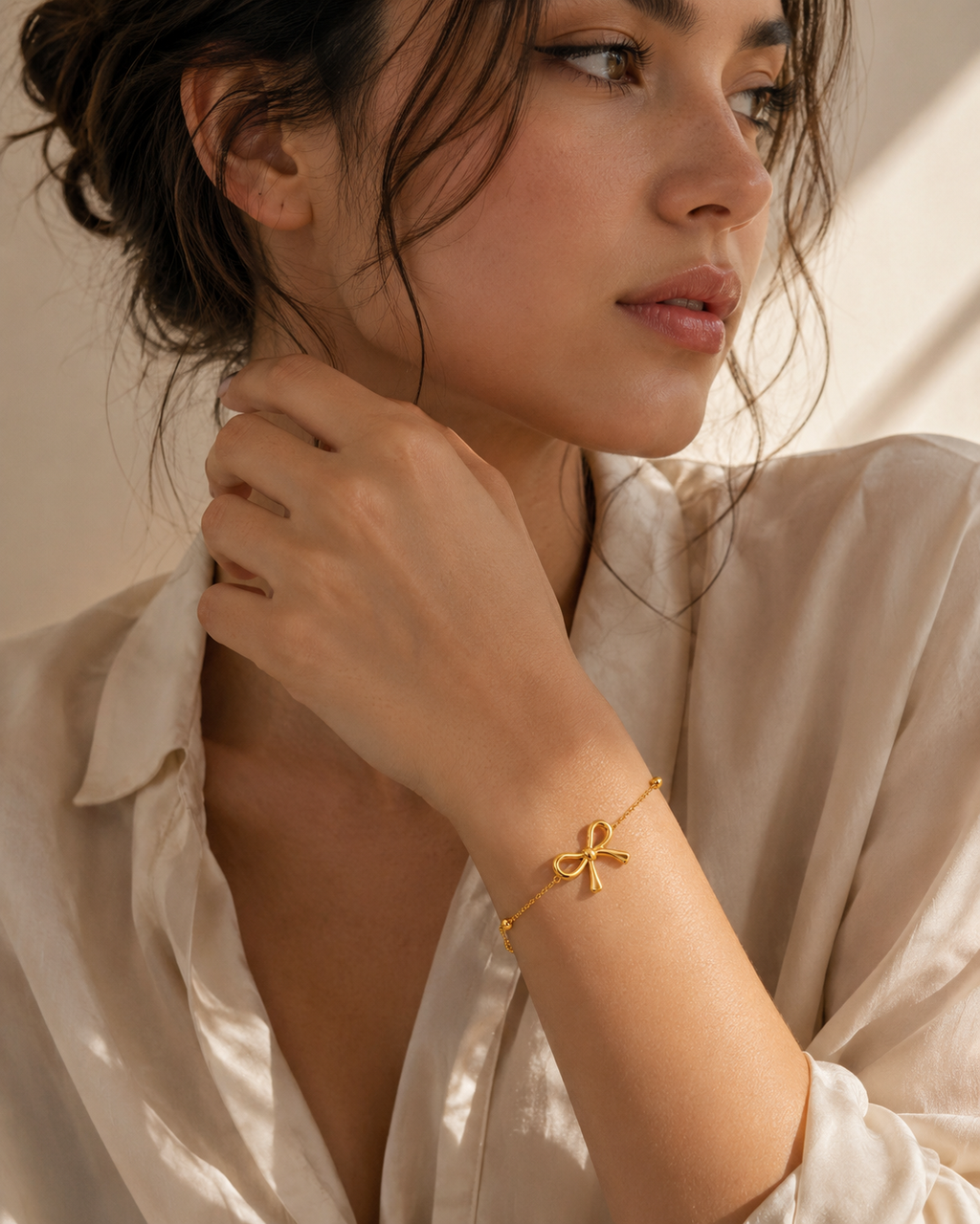 Woman wearing a gold bow,shaped bracelet for everyday look
