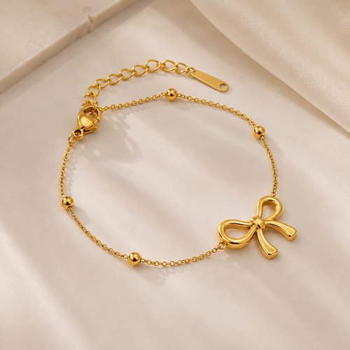 Gold bracelet with a bow charm for female everyday wear