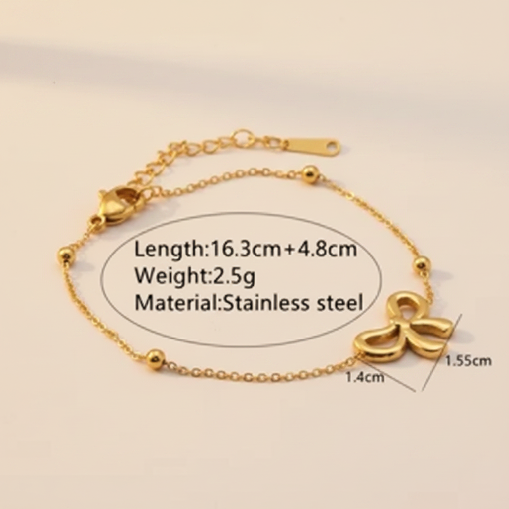 Gold bracelet with measurement details on a textured beige background