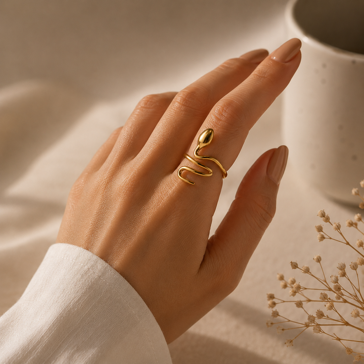 Hand wearing a gold ring Serpent Flow Ring