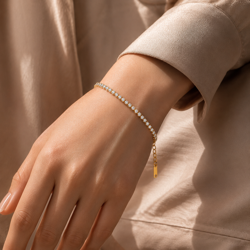 Close,up of a hand wearing a delicate bracelet on a neutral background