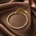 Gold bracelet with diamonds on a brown satin background