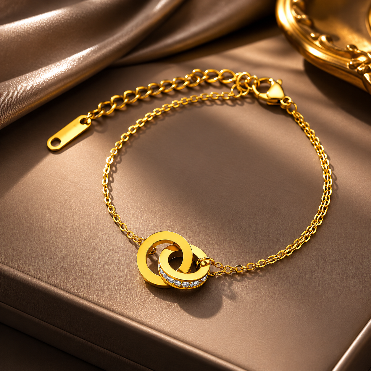 Gold bracelet with interlocking rings on a brown surface