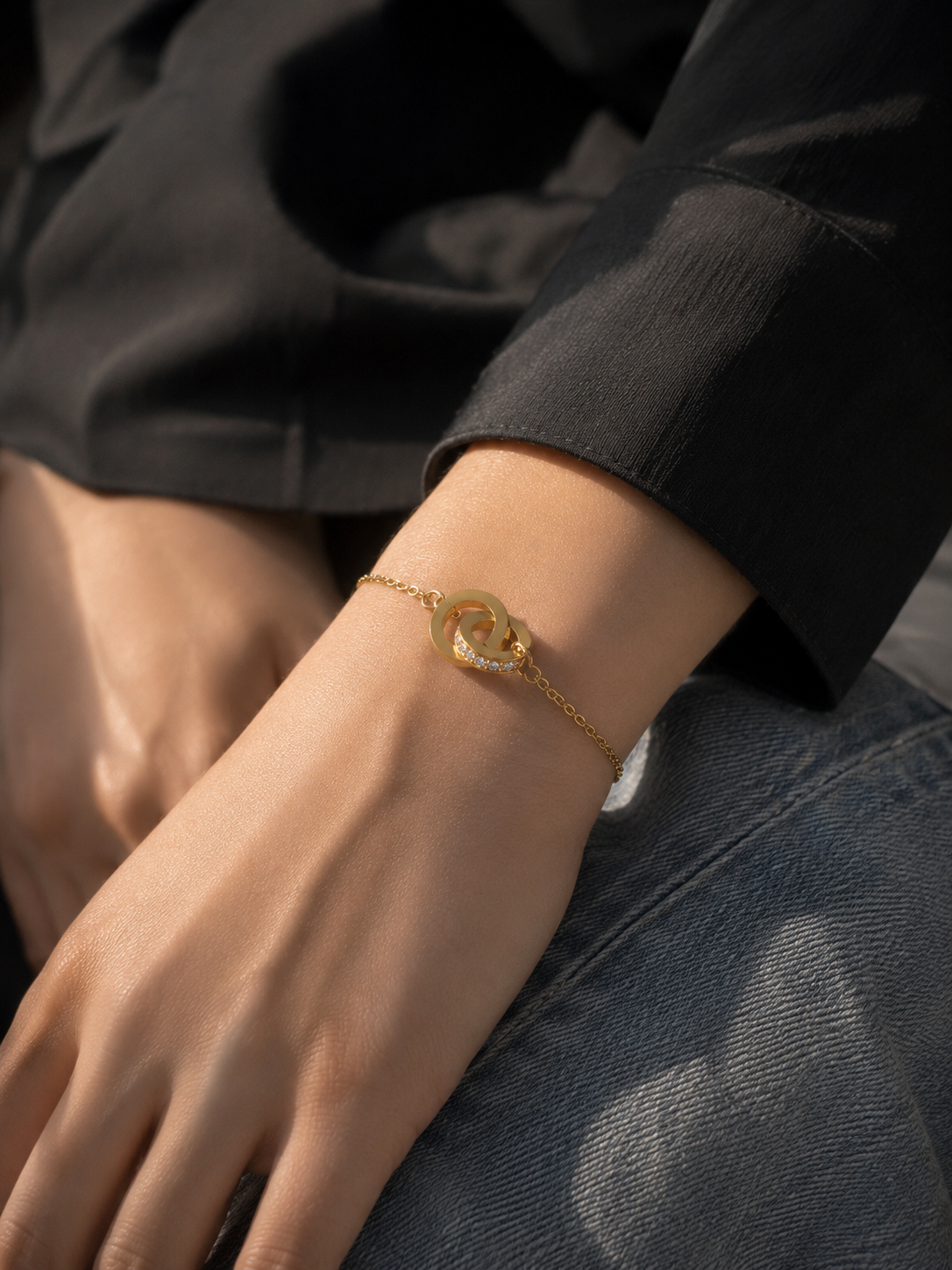 Gold bracelet on a wrist with a blurred background