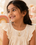 Young girl wearing a unicorn gold necklace with a pendant, smiling.