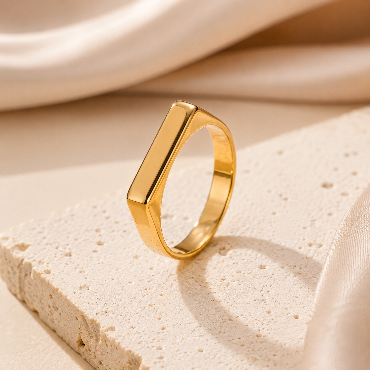 Gold ring on a beige fabric background