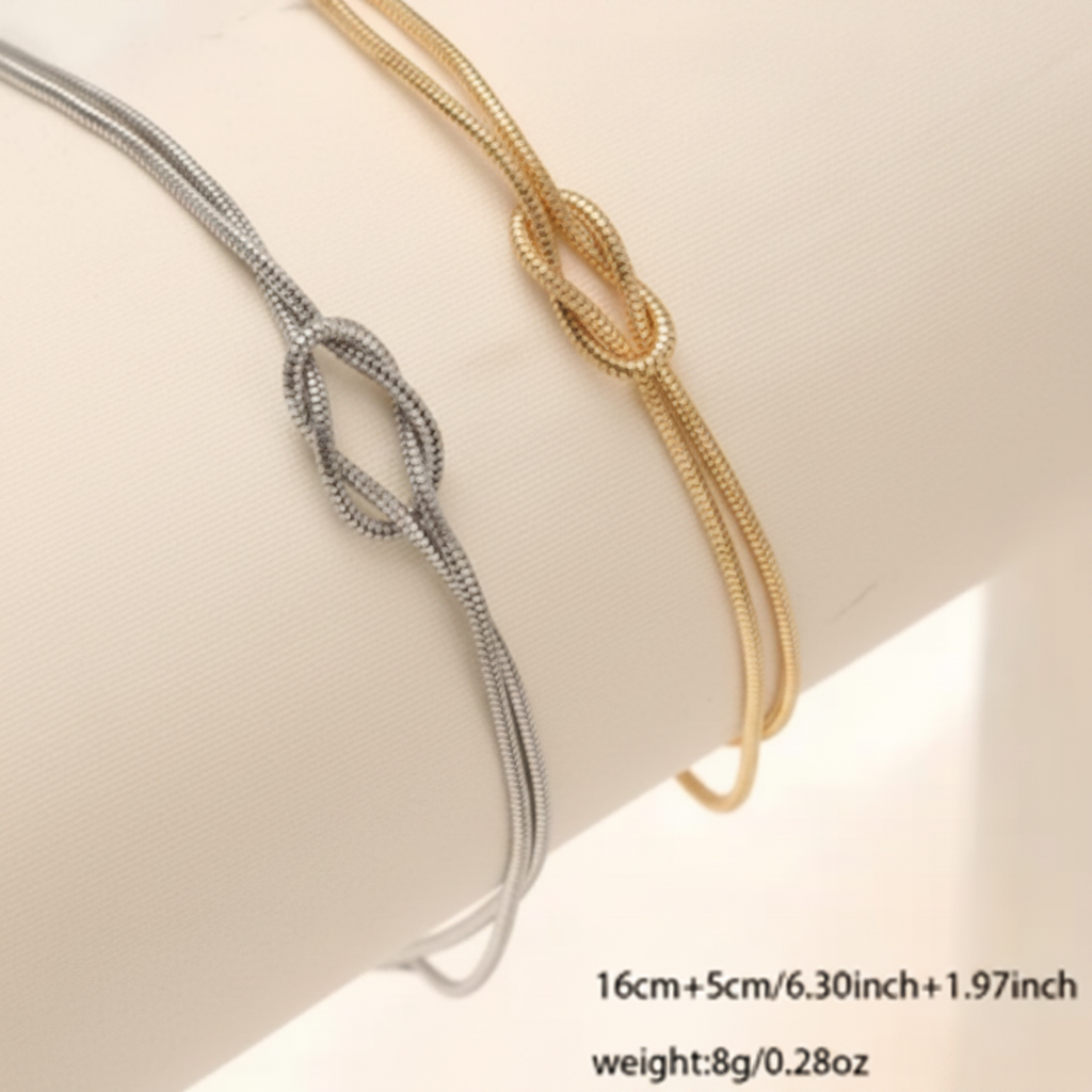 Two gold and silver bracelets on a white surface