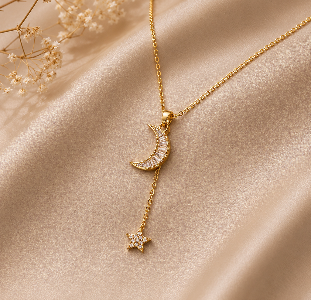 Gold necklace with a crescent moon and star pendant on a beige fabric background