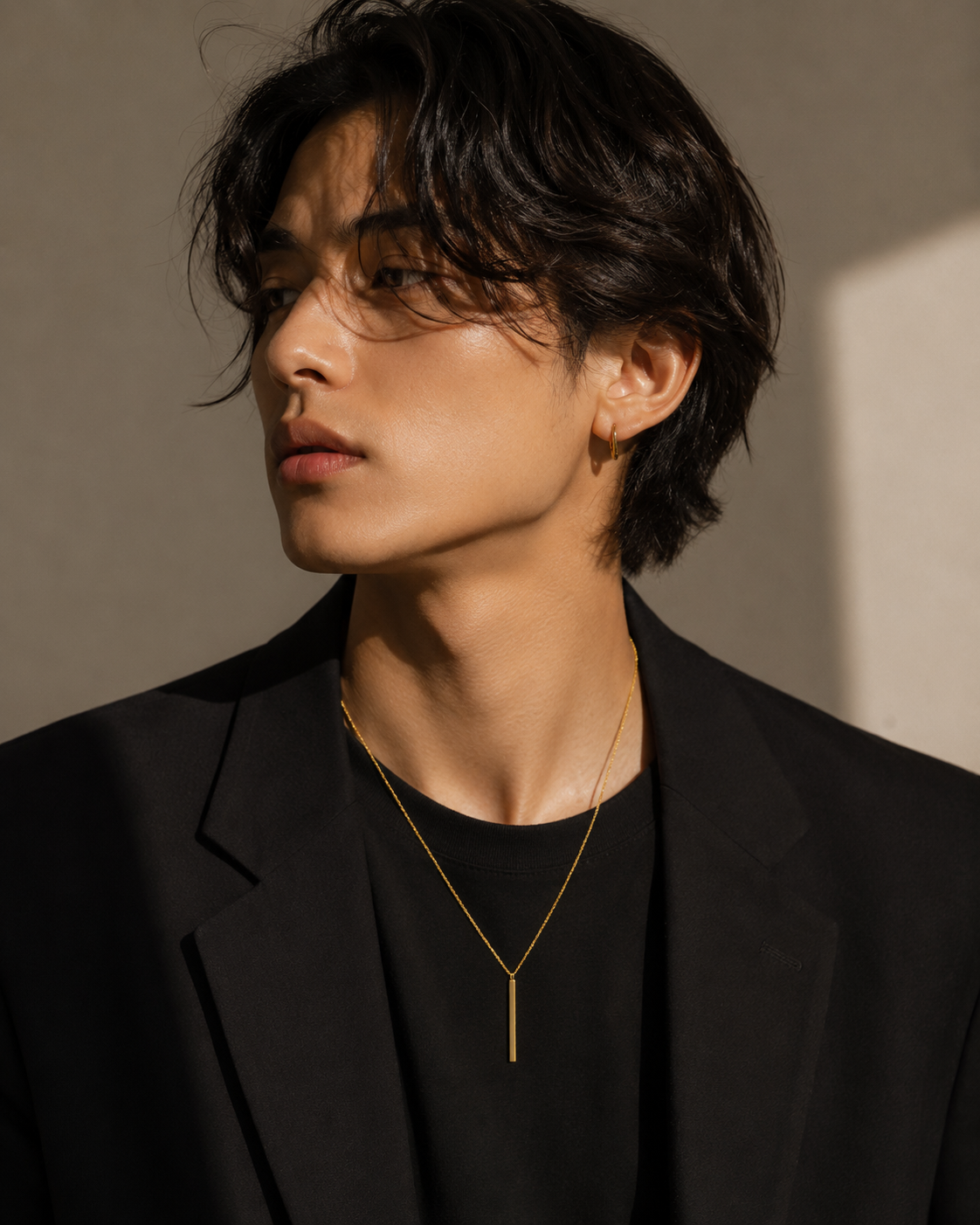 Person wearing a black blazer and gold necklace everyday wear, dress up or down