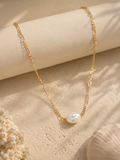 Gold necklace with a pearl pendant for beach wear 