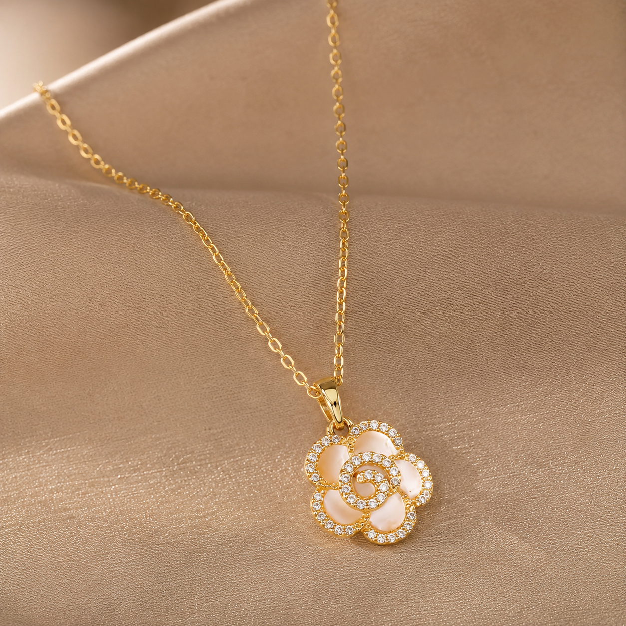 Gold necklace with a floral pendant on a beige background