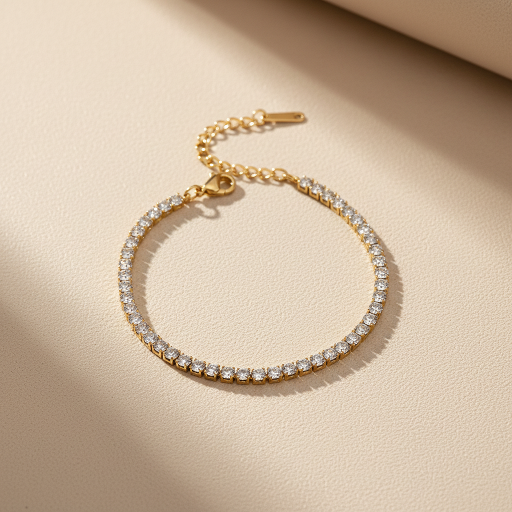 Gold bracelet with clear stones on a beige box with a black background